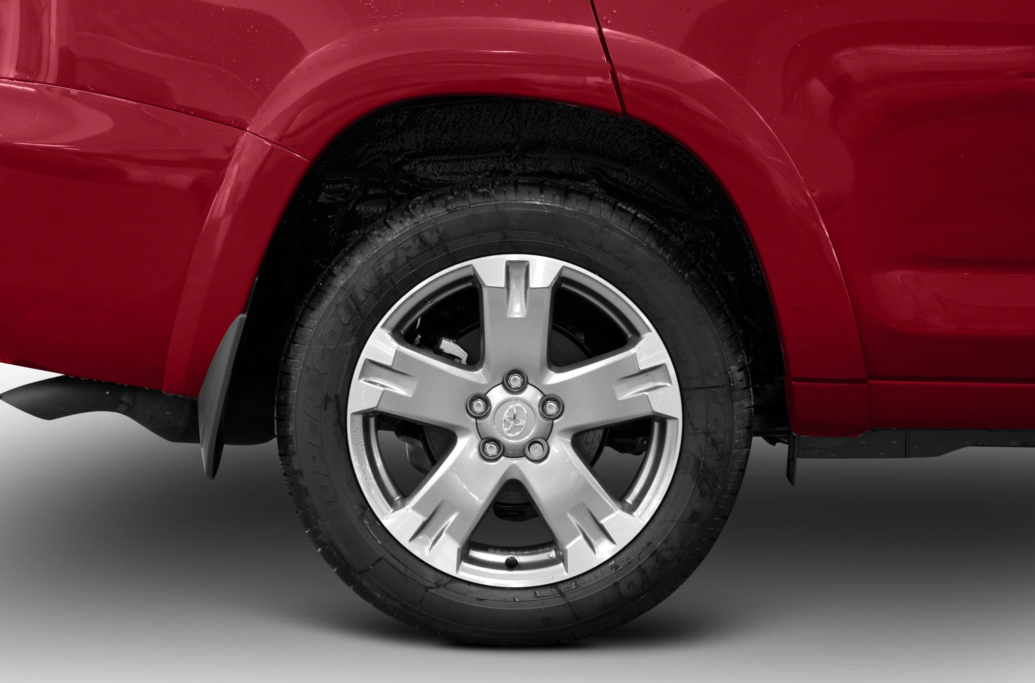 Alloy wheel and tire close-up on red SUV