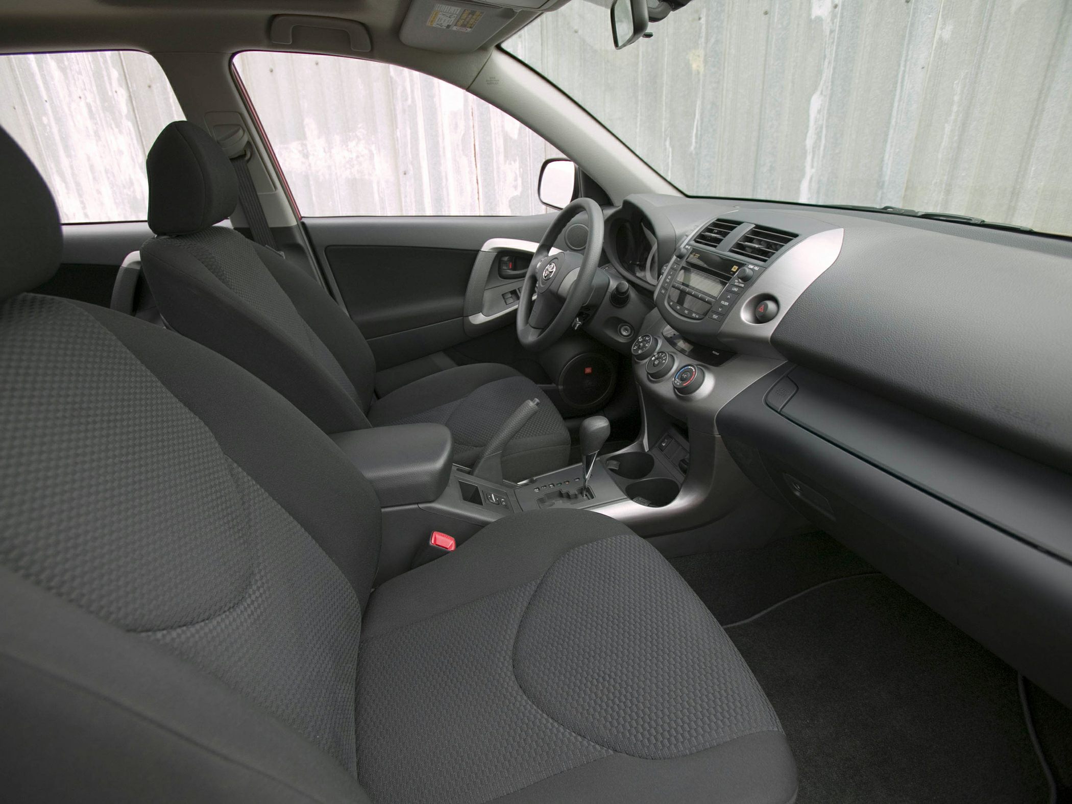 Interior view with dashboard, seats, steering wheel, and center console
