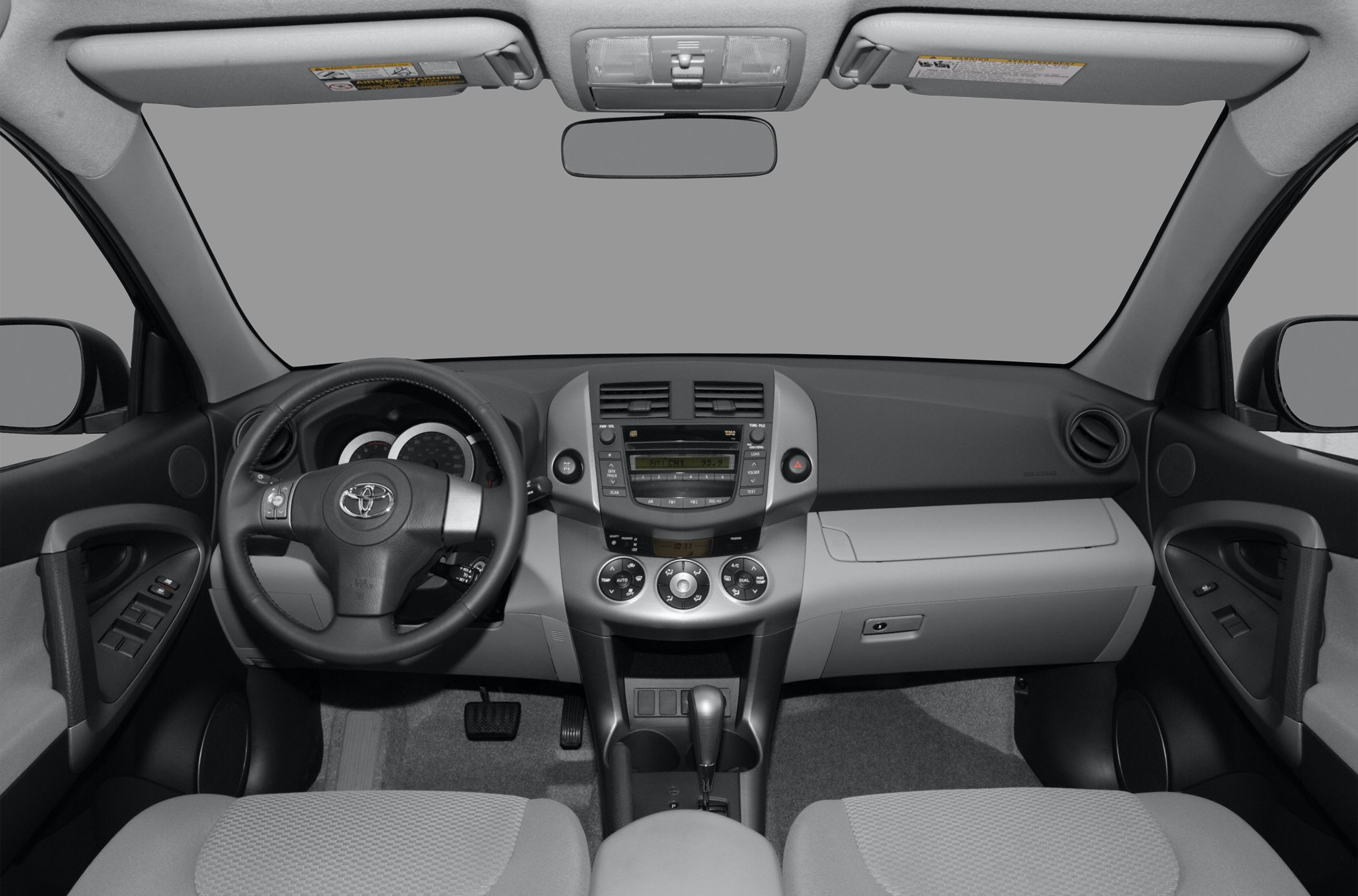 Dashboard with steering wheel, center console, and controls inside a vehicle interior