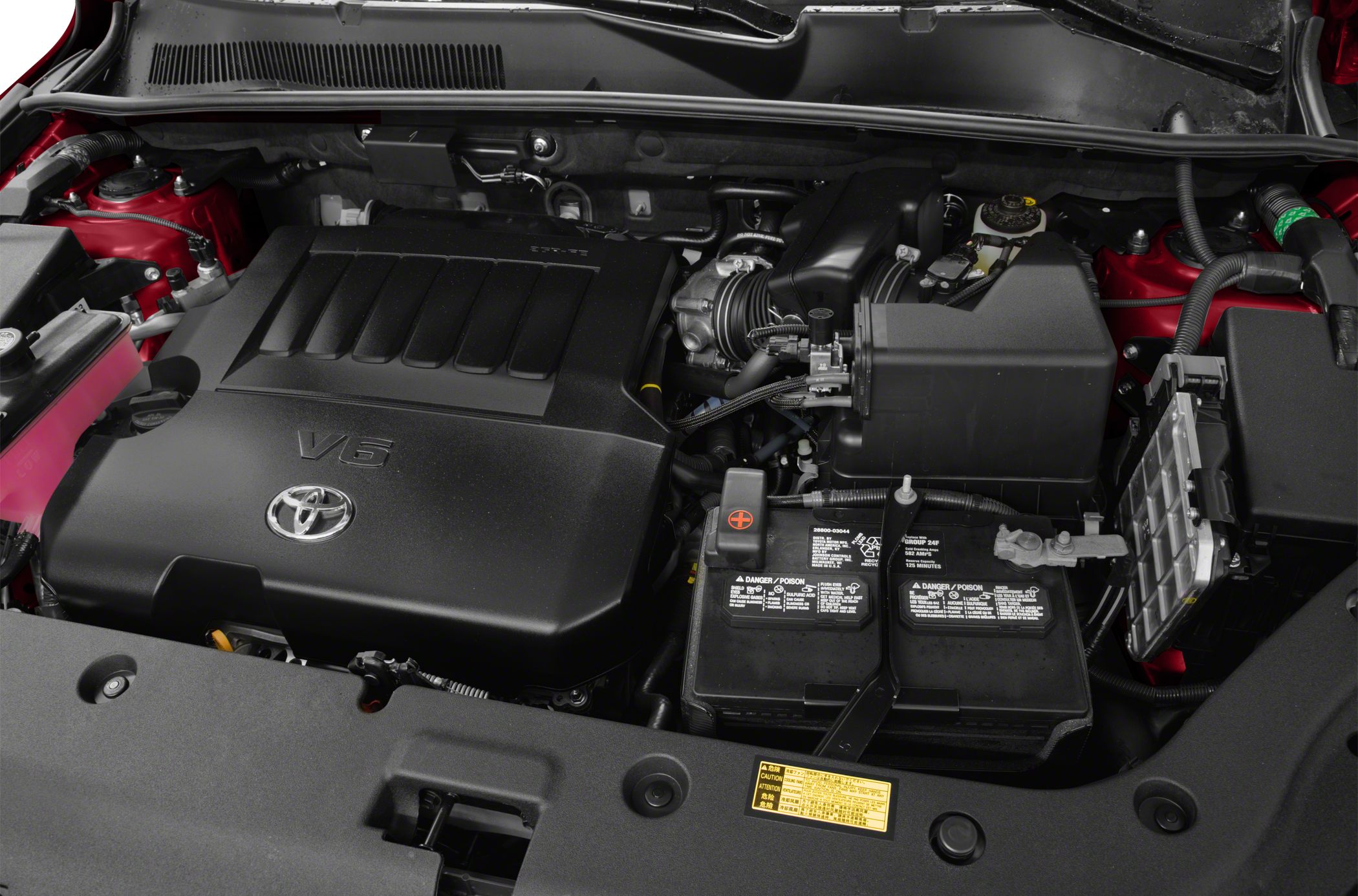 V6 engine with cover and car battery in engine compartment