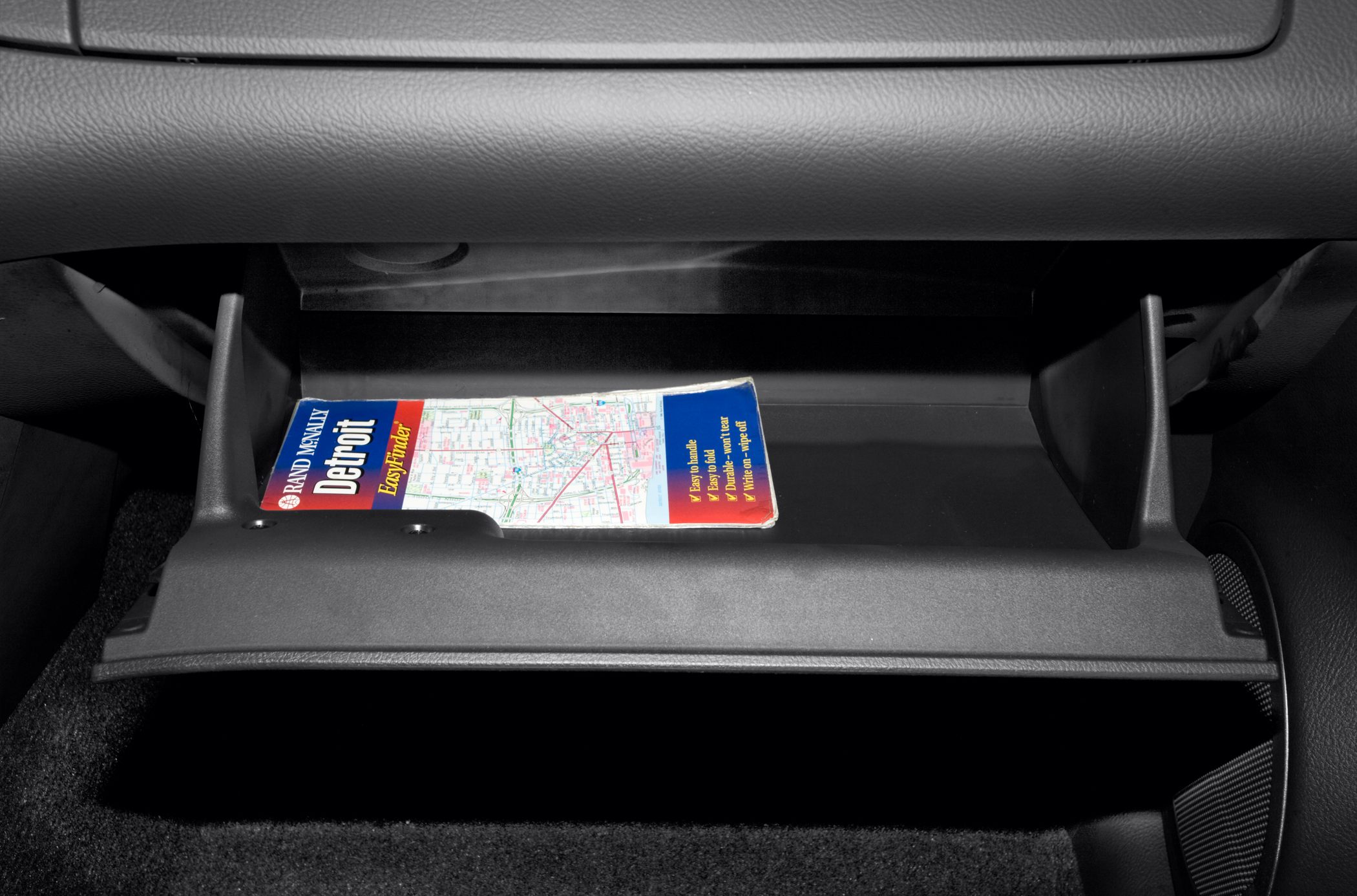 Open glove box with a city map inside
