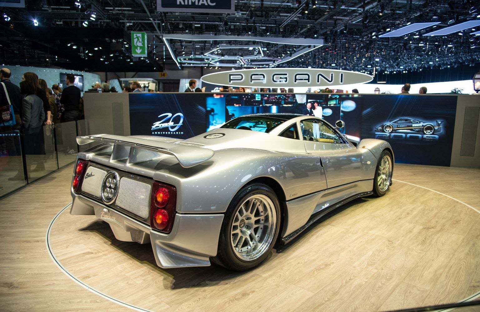 Rear view of a silver sports car with prominent aerodynamic wing and distinctive rear lights