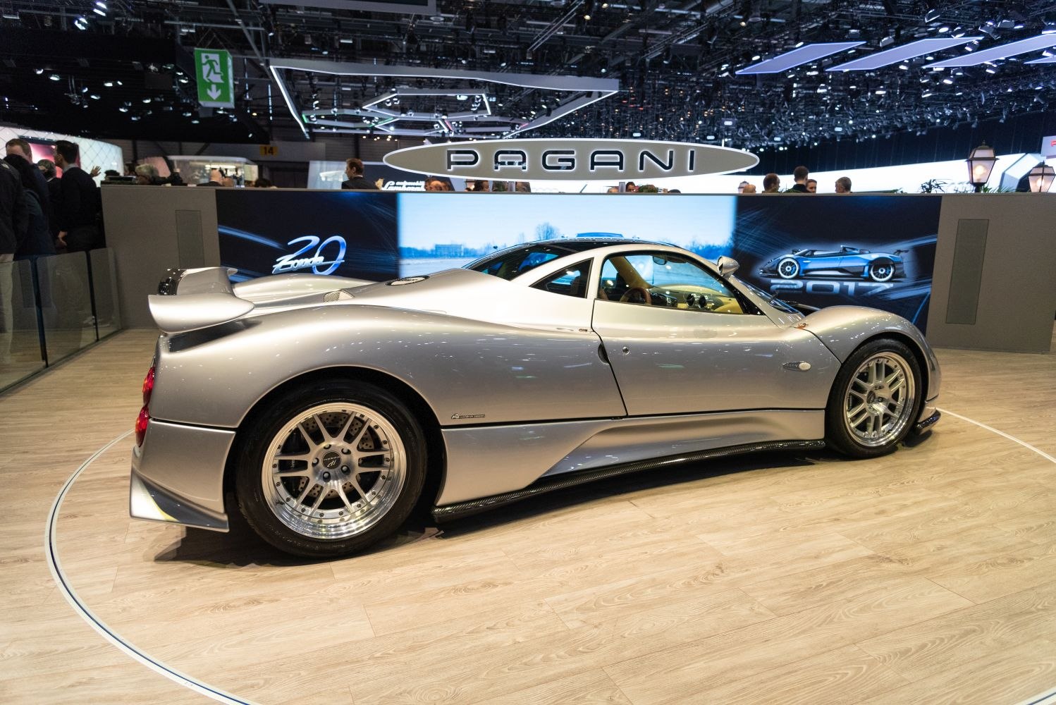 Silver supercar side view with aerodynamic shape and alloy wheels.