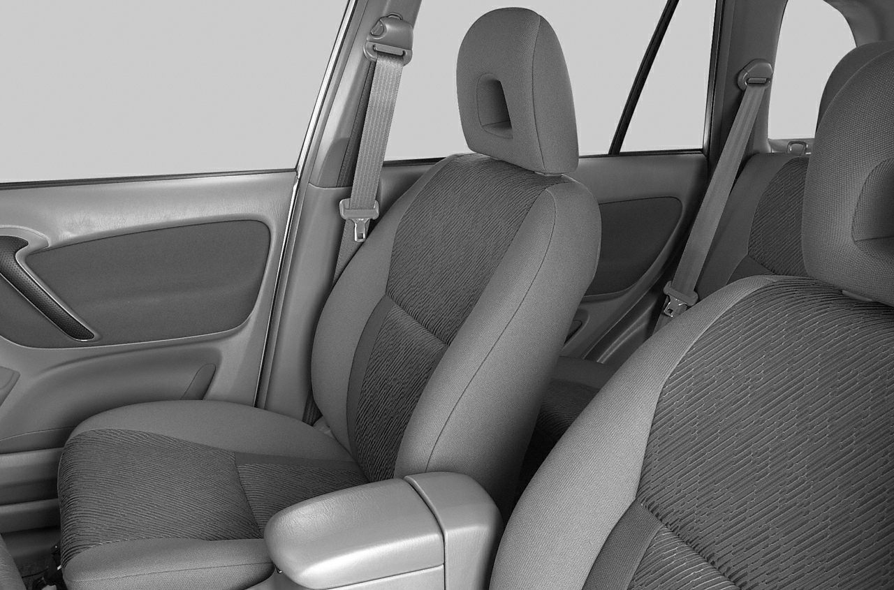 Front fabric seats with seatbelts, armrest, and door panel details