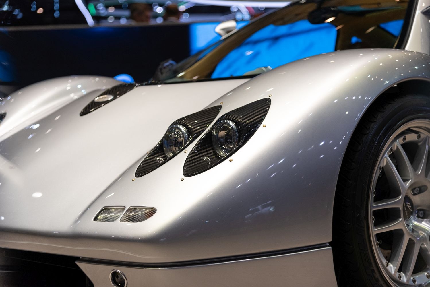Close-up of car front headlights and alloy wheel detail