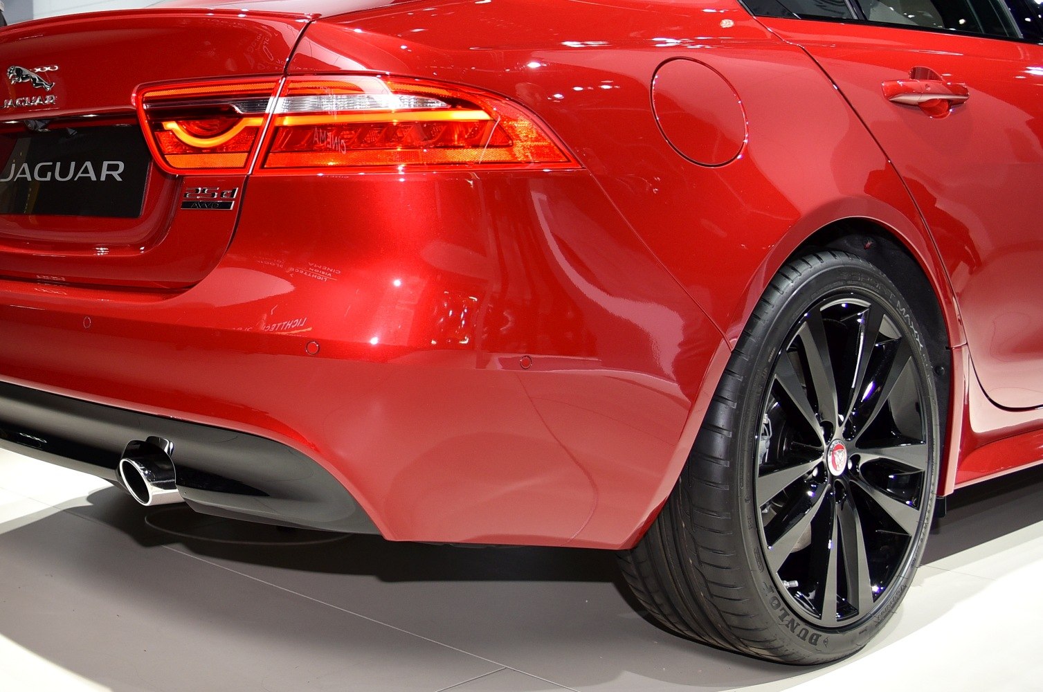 Rear section with distinct taillight and black alloy wheel close-up
