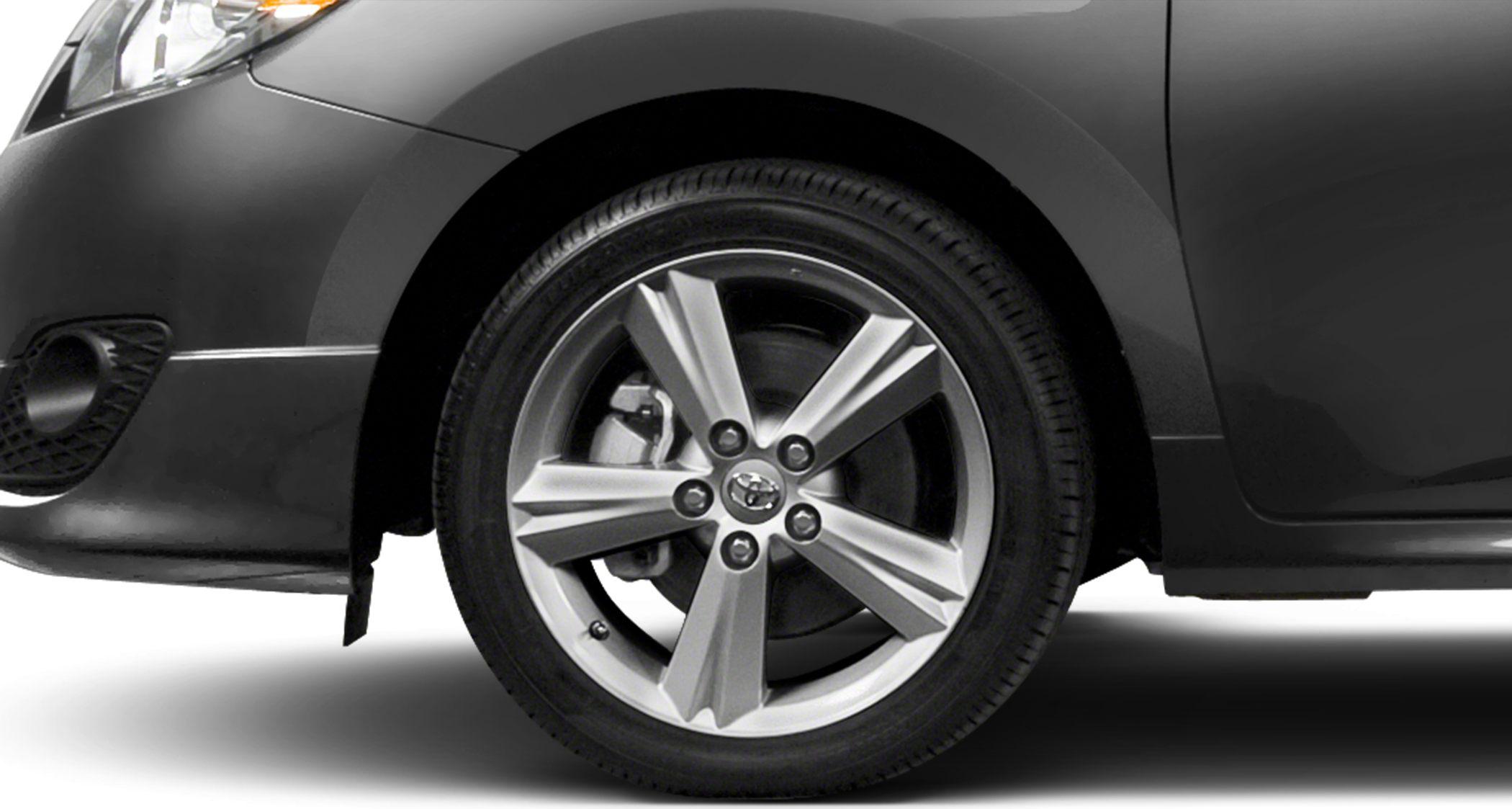 Close-up of alloy wheel, rim design, brake caliper, and front fender details