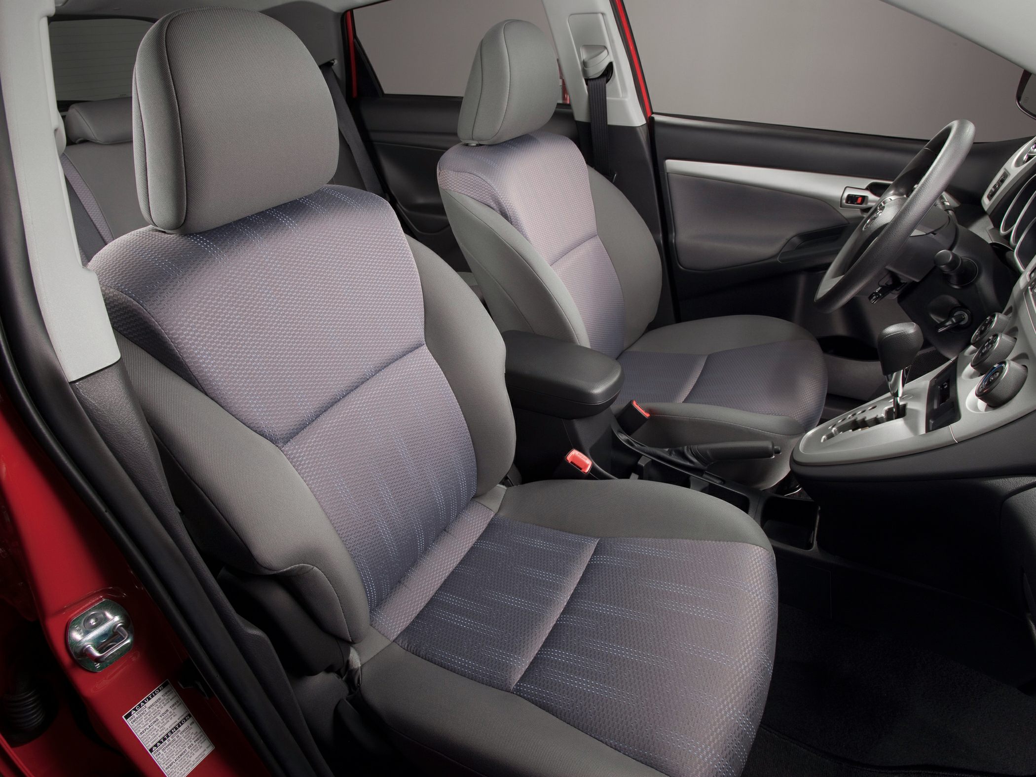 Fabric front seats with center console armrest and dashboard with gear shift