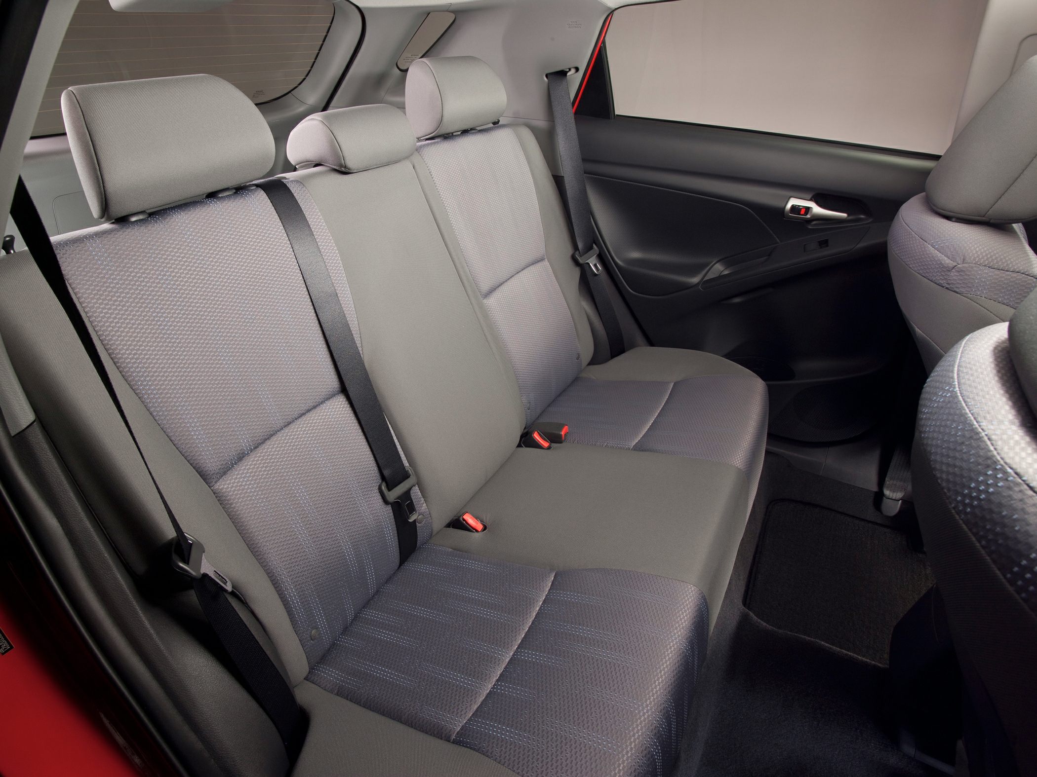 Rear passenger seats with fabric upholstery and seatbelts
