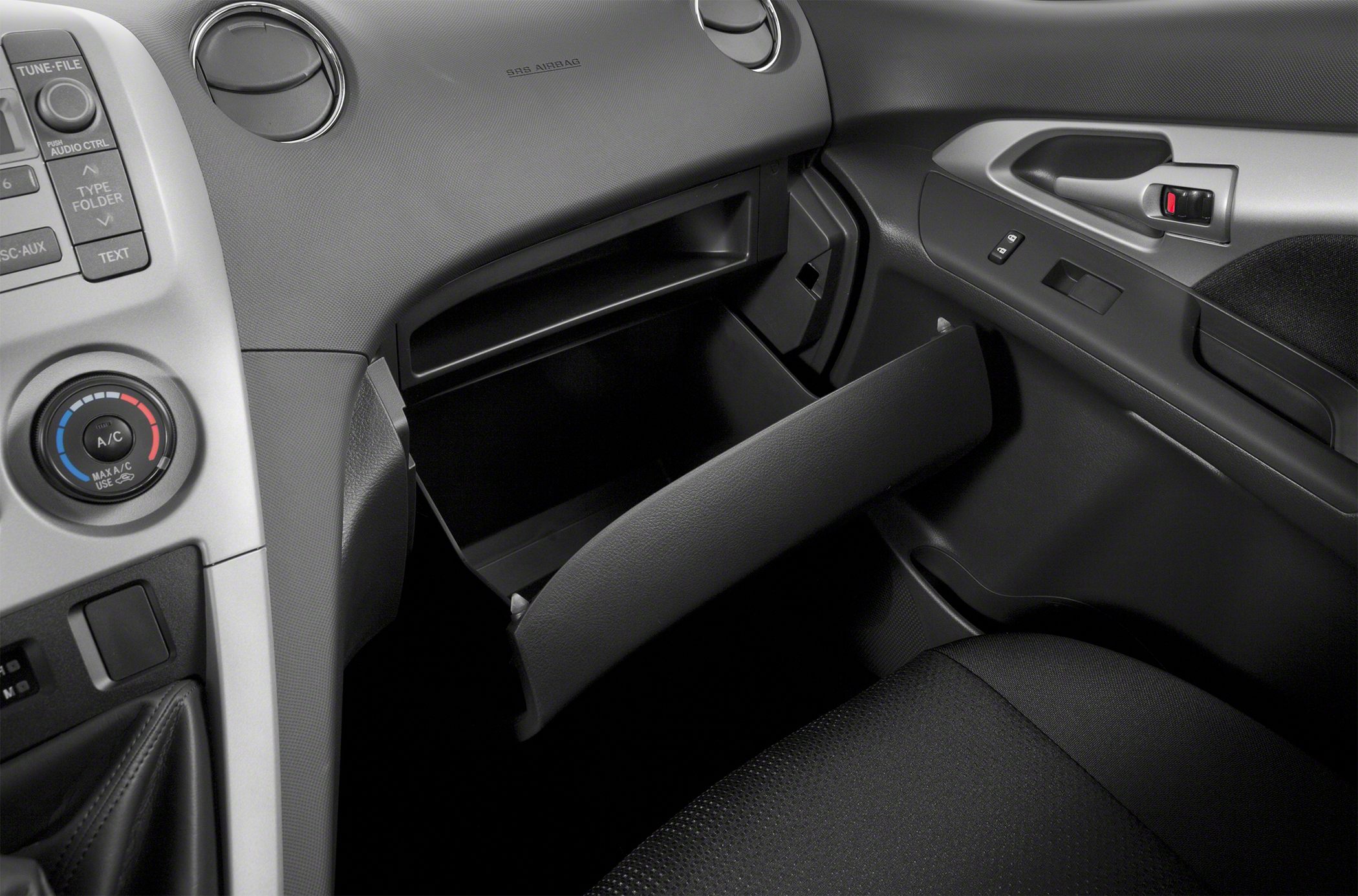 Open glove compartment with dashboard and AC controls