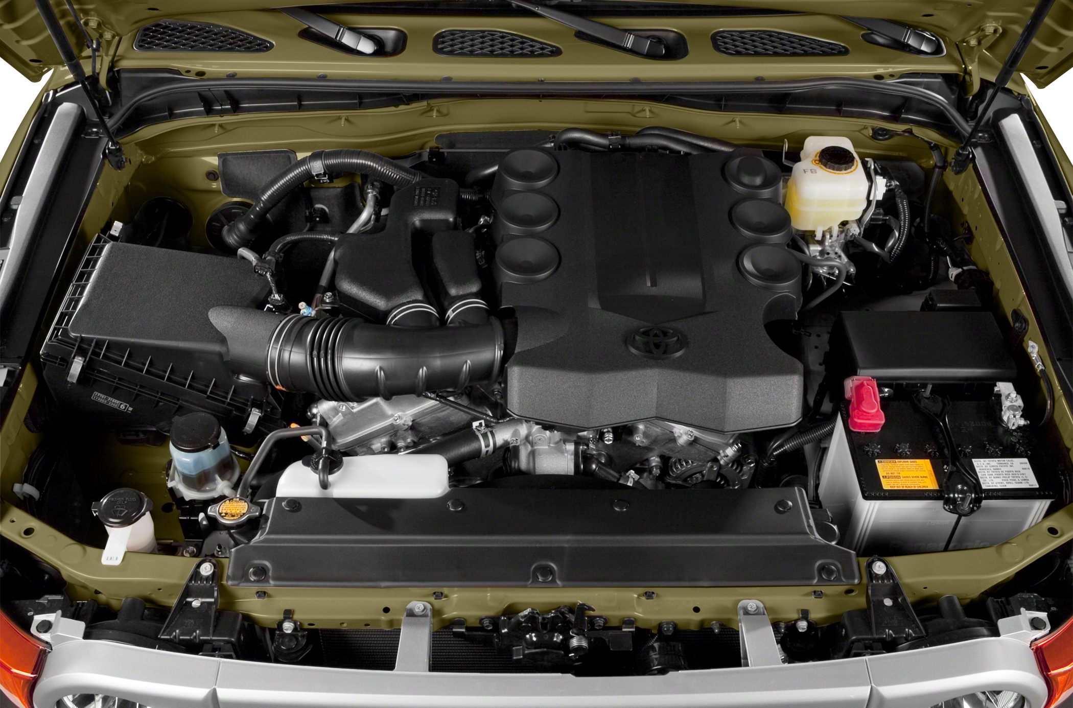 Engine bay of an SUV with air intake, battery, and fluid reservoirs.