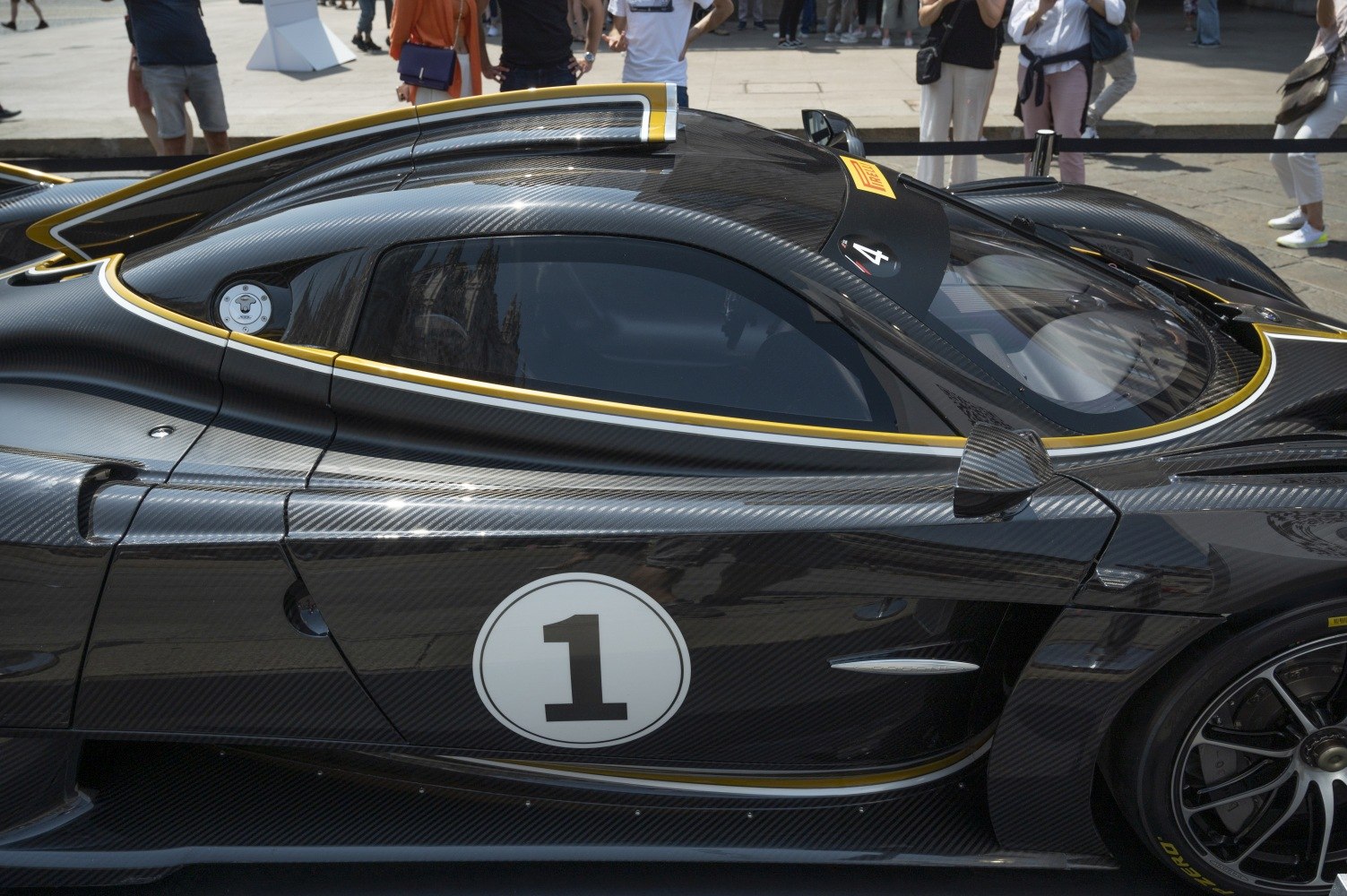 Carbon fiber race car side with aerodynamic body and number 1 decal