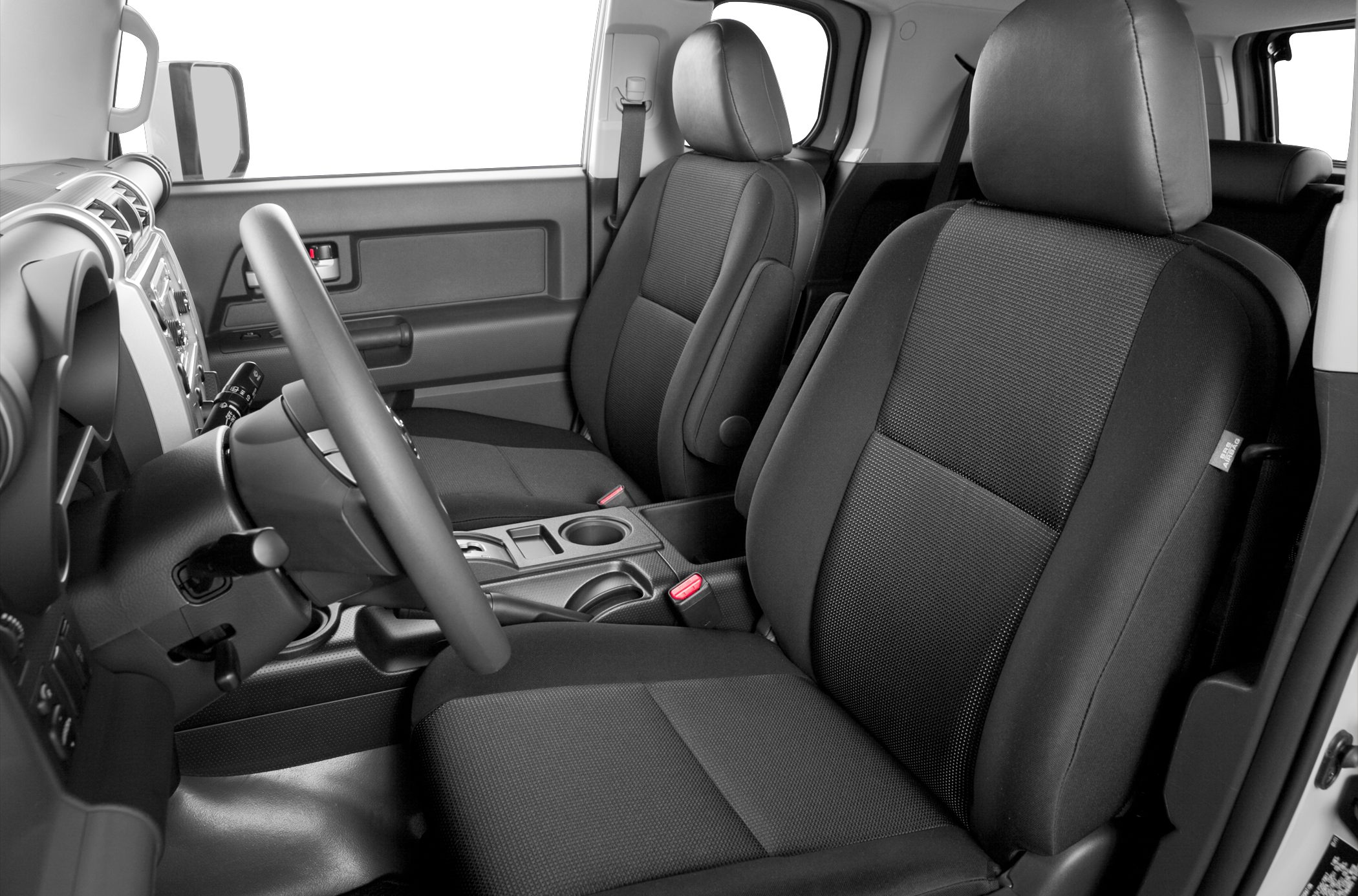 Spacious front seats and dashboard with steering wheel inside SUV cabin