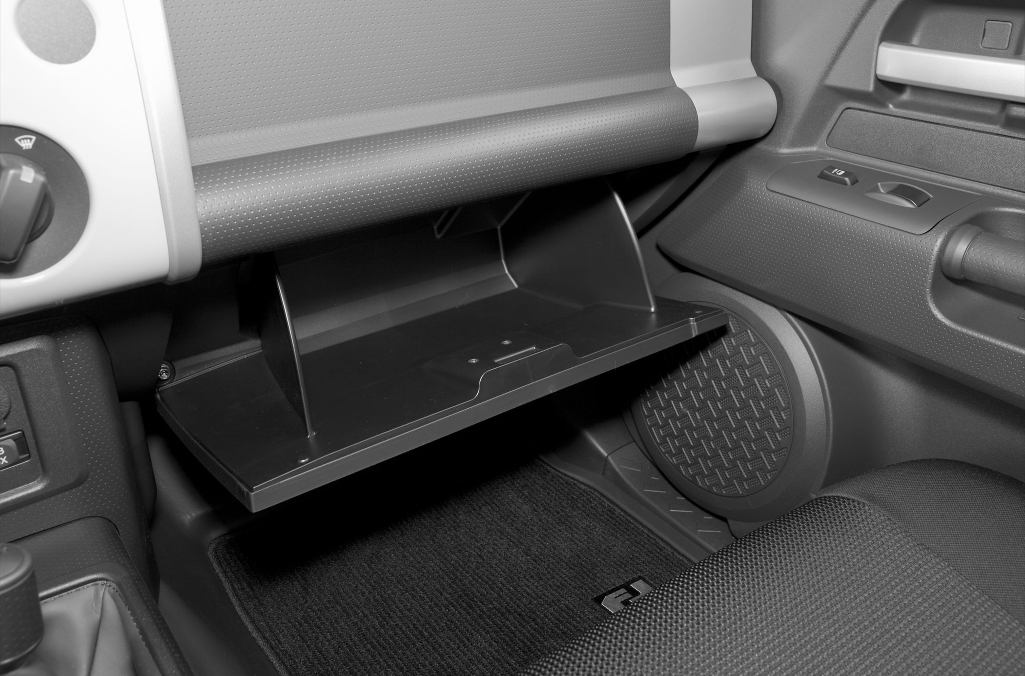 Open glove box and interior storage compartment with textured floor mat