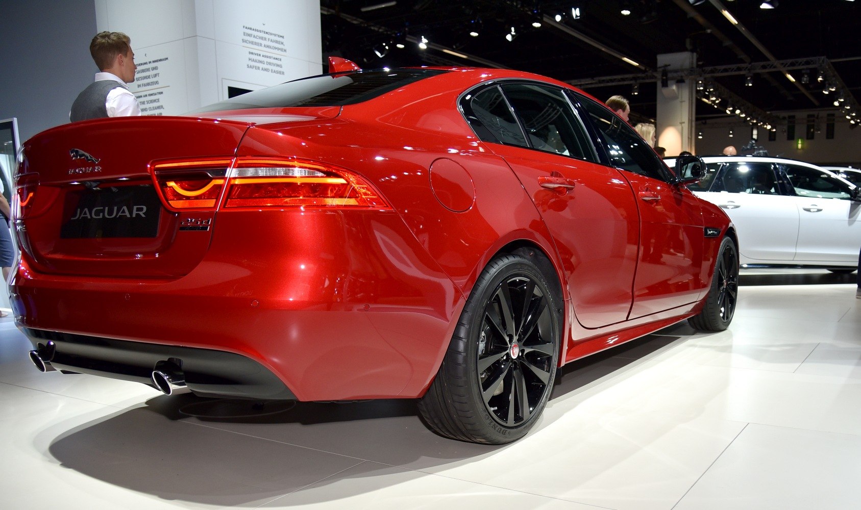 Red sedan rear and side view with taillights and black rims