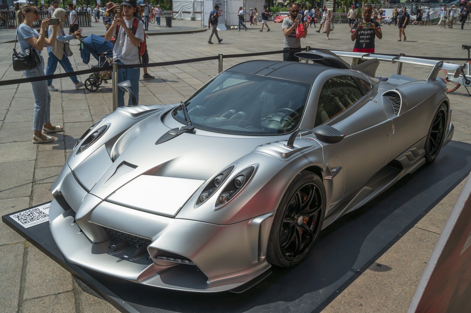 Silver hypercar with aerodynamic design and unique headlight cluster