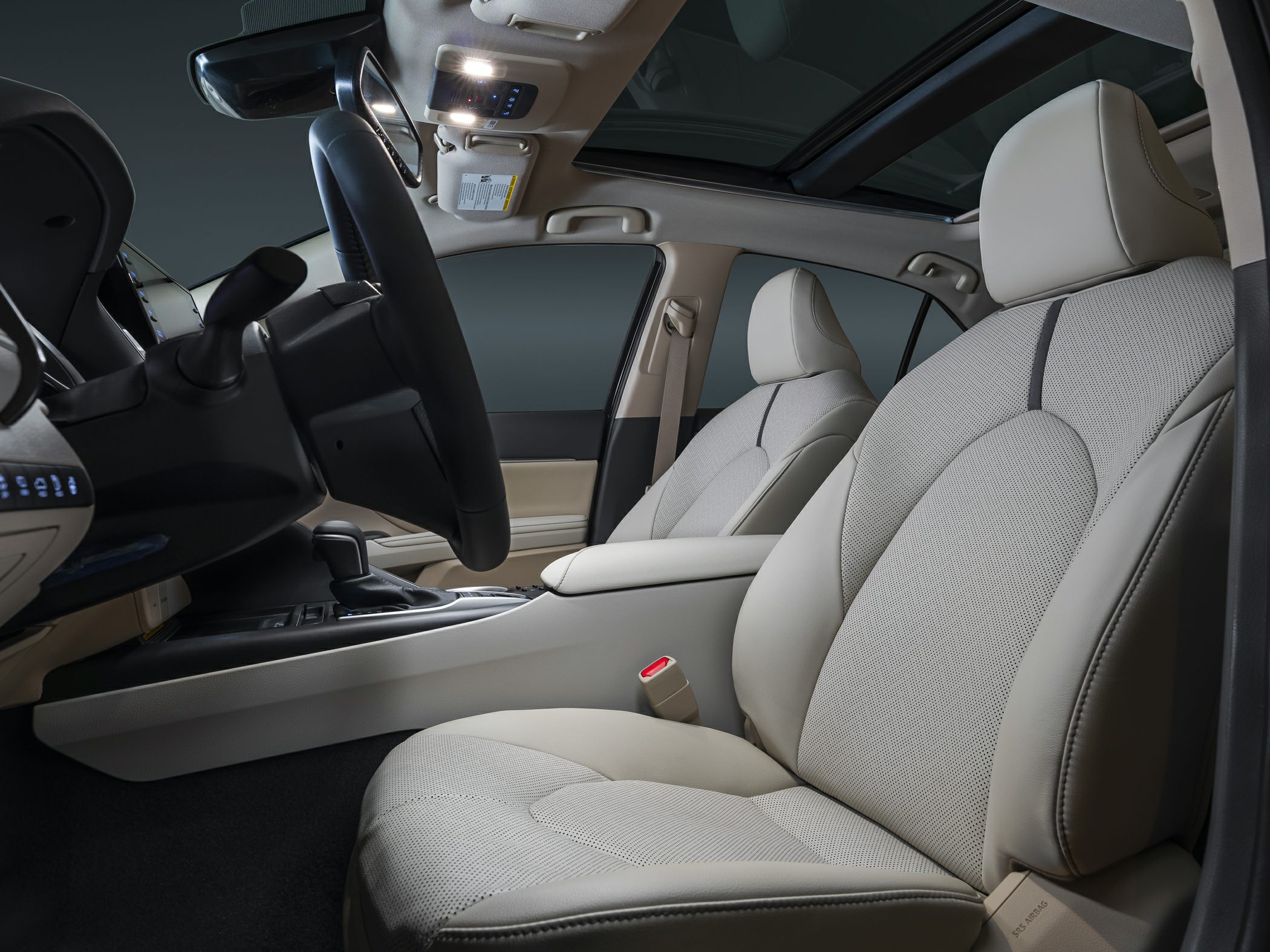 Beige front seats and dashboard with panoramic sunroof