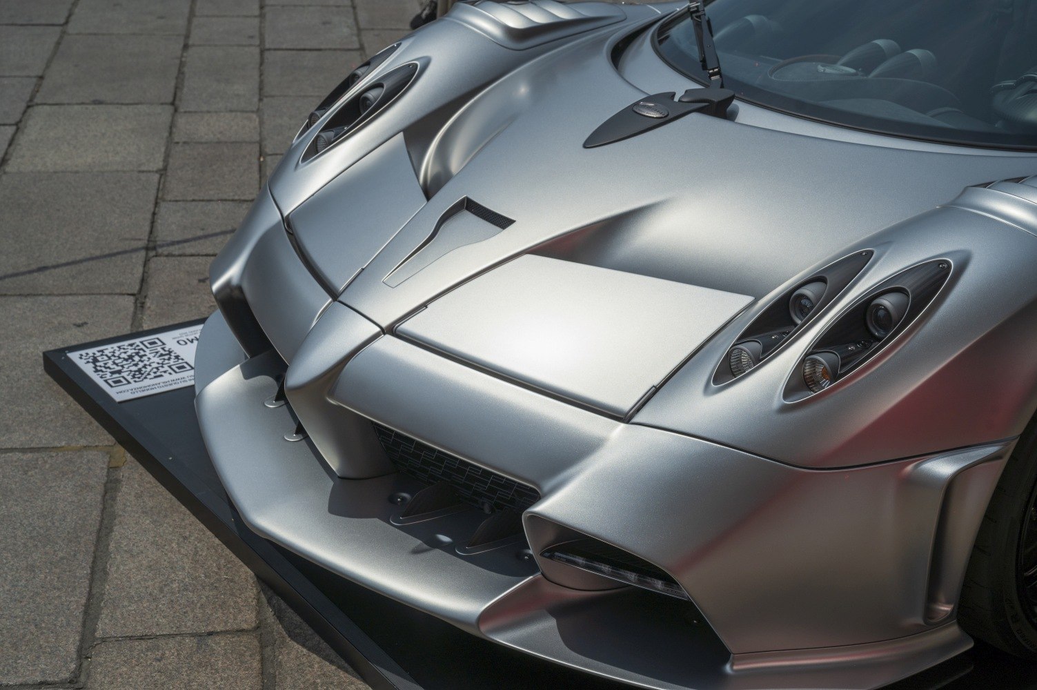 Front aerodynamic design with quad headlights and aggressive venting.