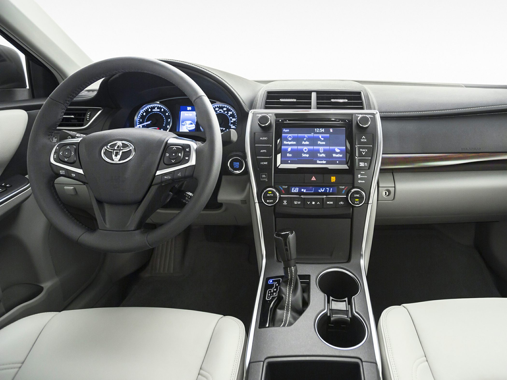 Steering wheel with controls and a central touchscreen dashboard showing climate and media options
