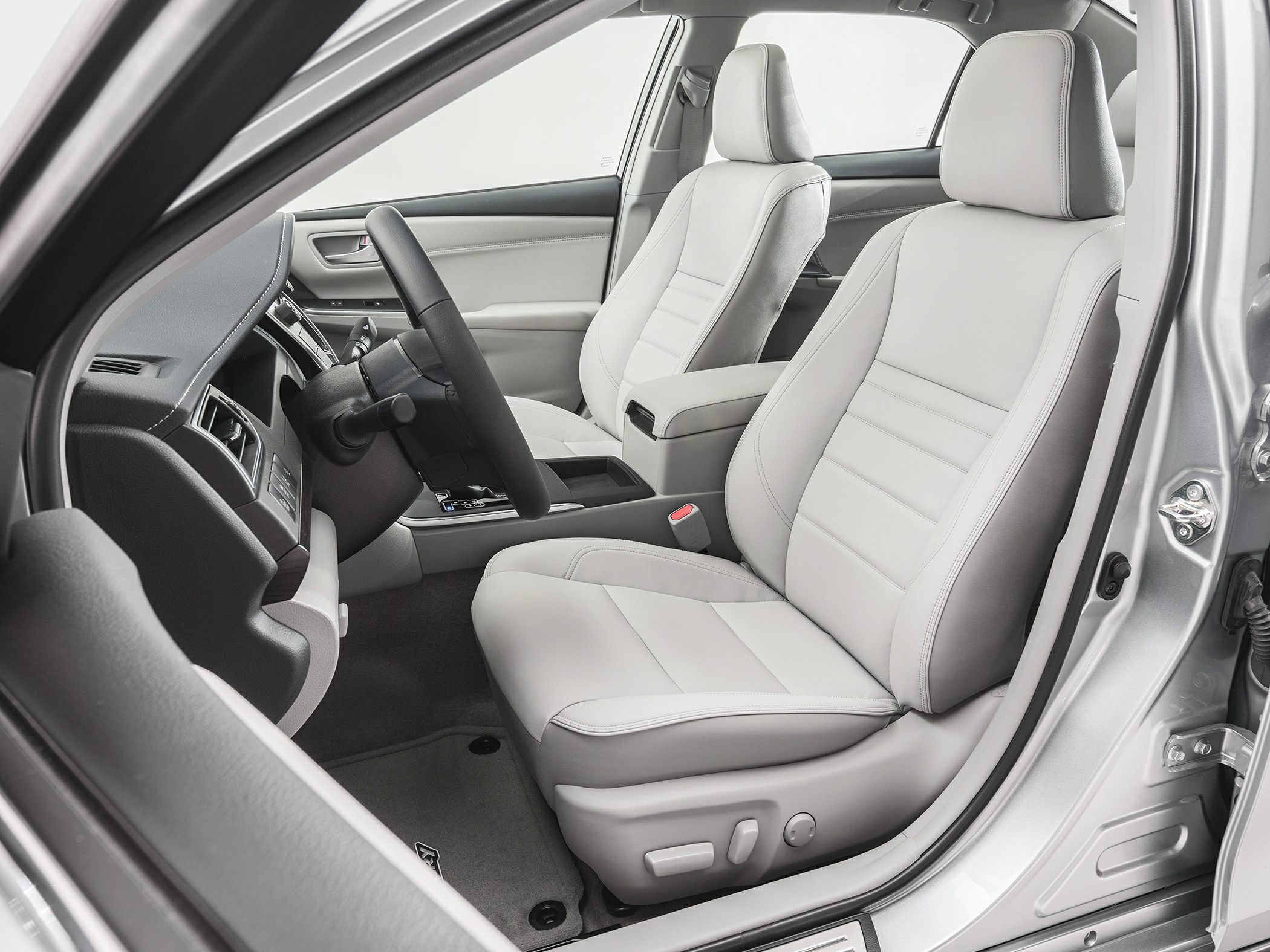 Light-colored leather front seats and dashboard layout