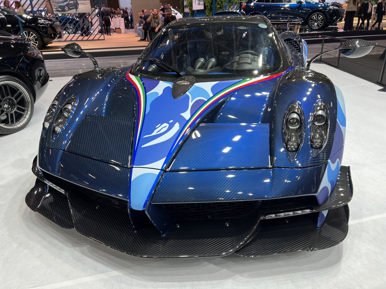 Carbon fiber front fascia with blue graphic accents and distinctive headlights