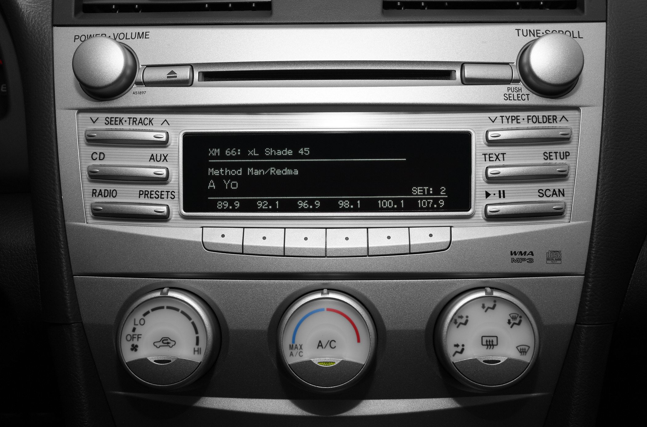 Toyota Camry stereo system with CD, AUX, and climate control knobs