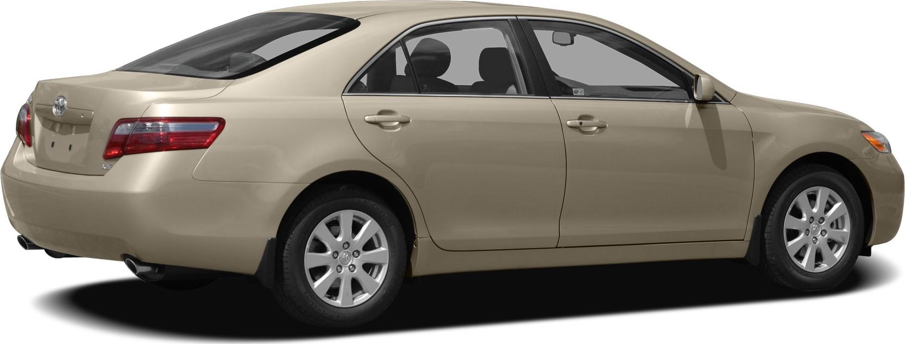 Rear side view of a mid-size four-door sedan with alloy wheels in beige.