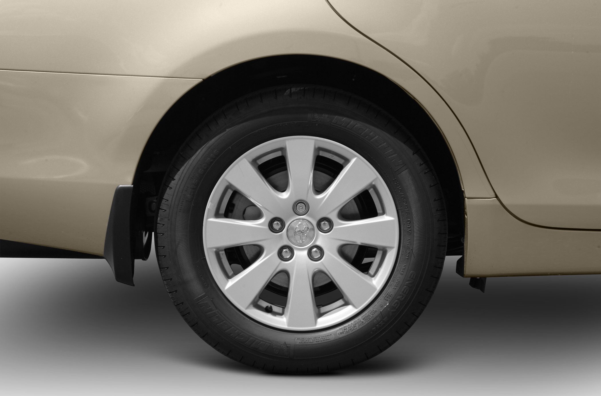 Silver alloy wheel with Michelin tire on car rear side