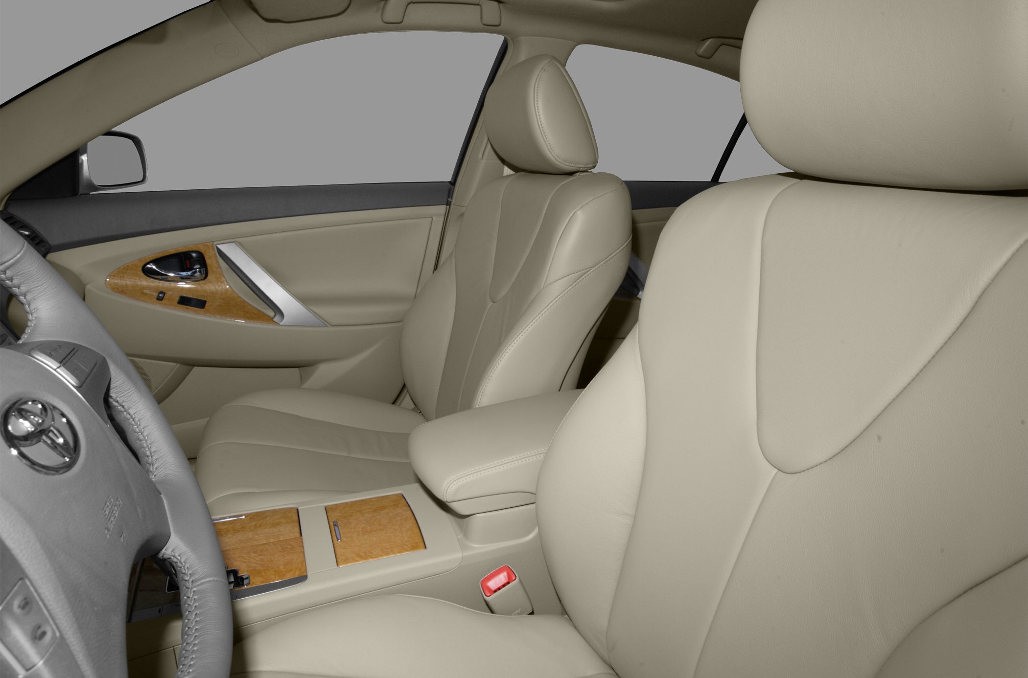 Beige leather seats with wood trim and armrest in car interior