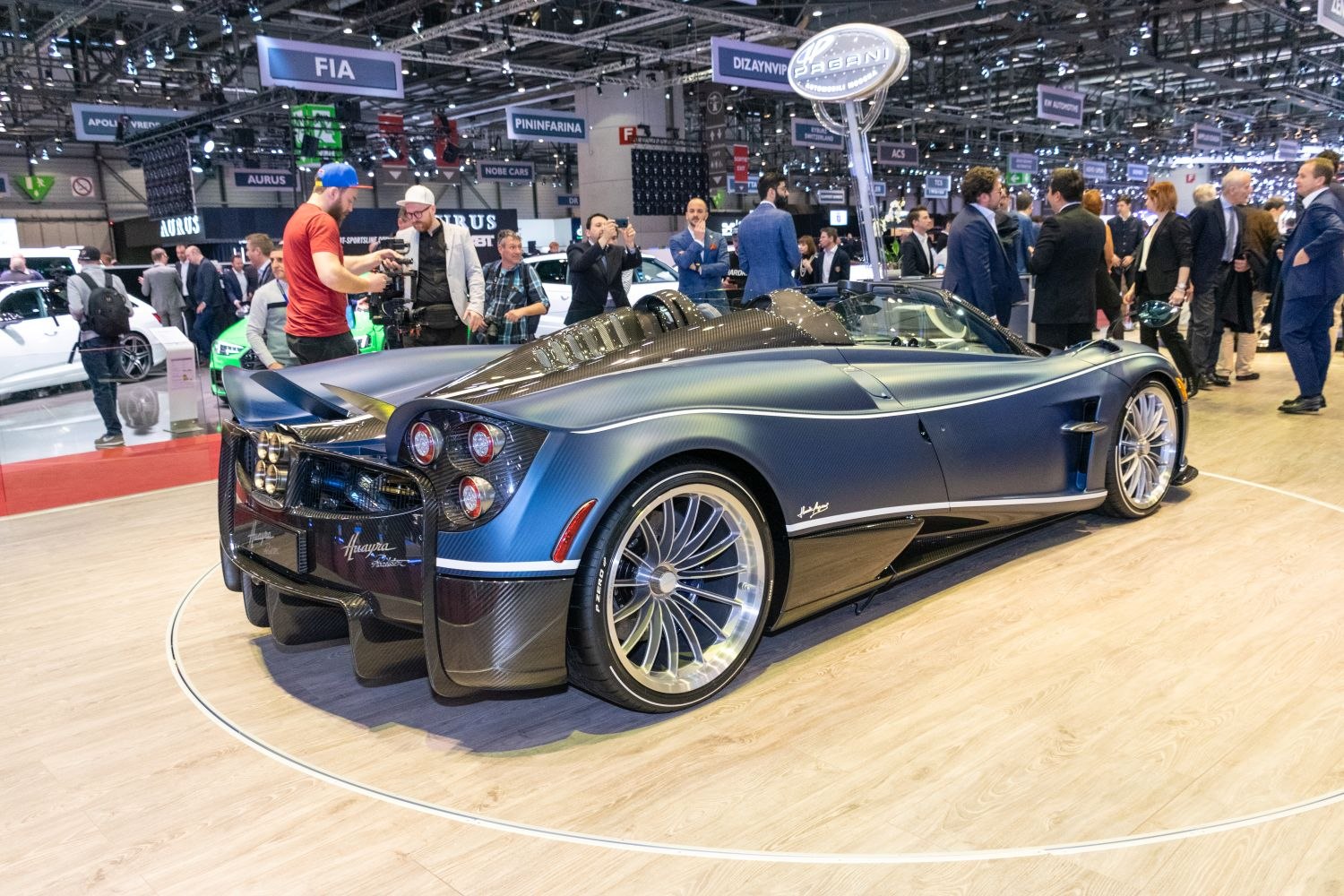 Rear and side view of carbon fiber luxury roadster with aerodynamic design and distinctive taillights.