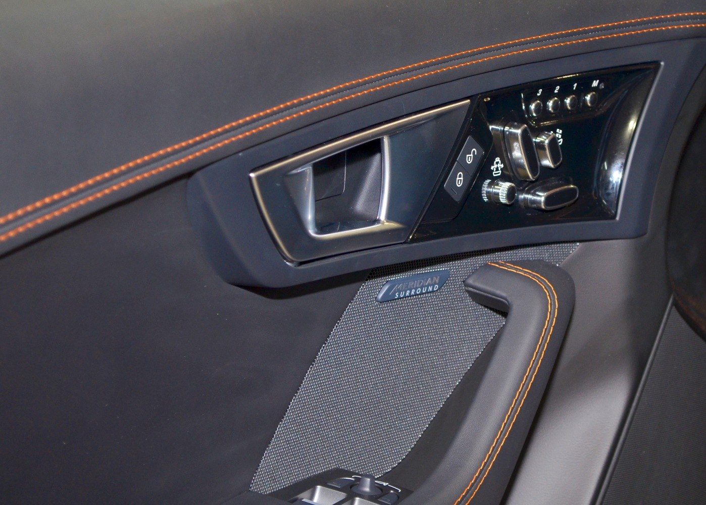Interior door panel with control buttons and Meridian surround sound speaker