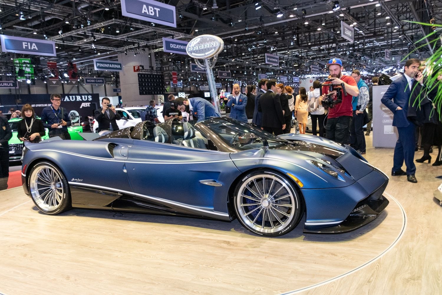 Sleek side profile of an open-top exotic roadster with intricate aerodynamic features.