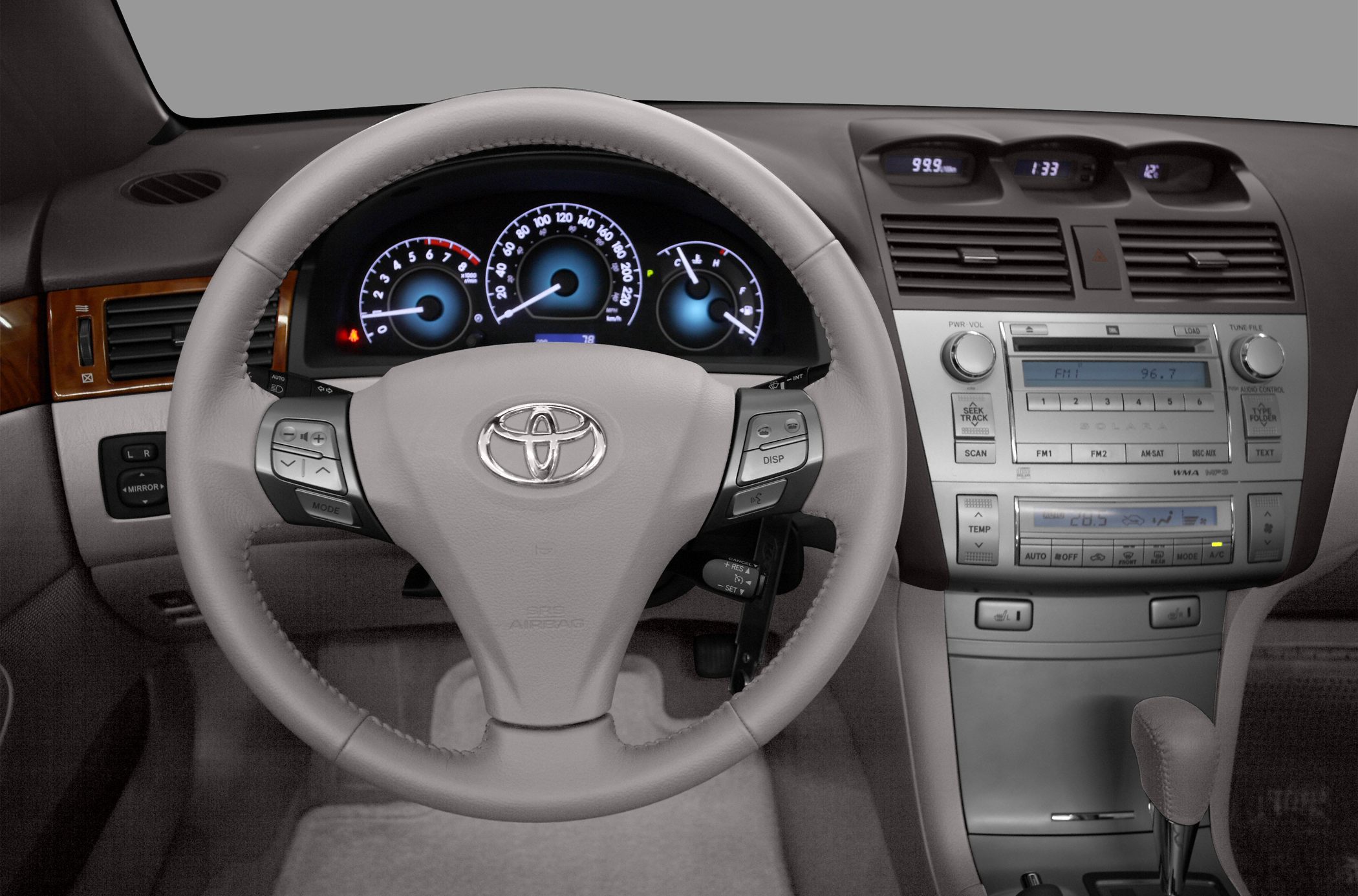 Steering wheel and dashboard layout with controls and displays