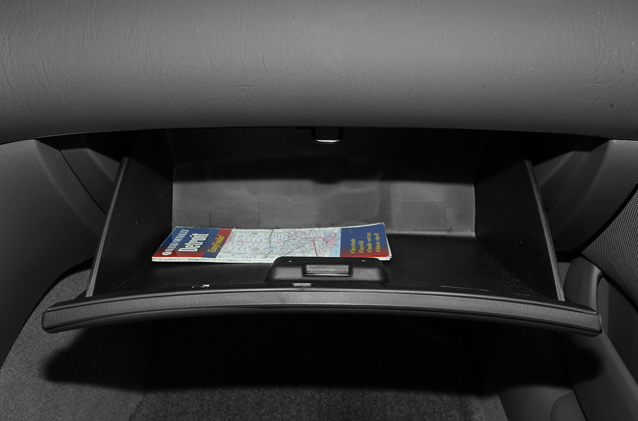 Open glove compartment with map inside, interior storage space