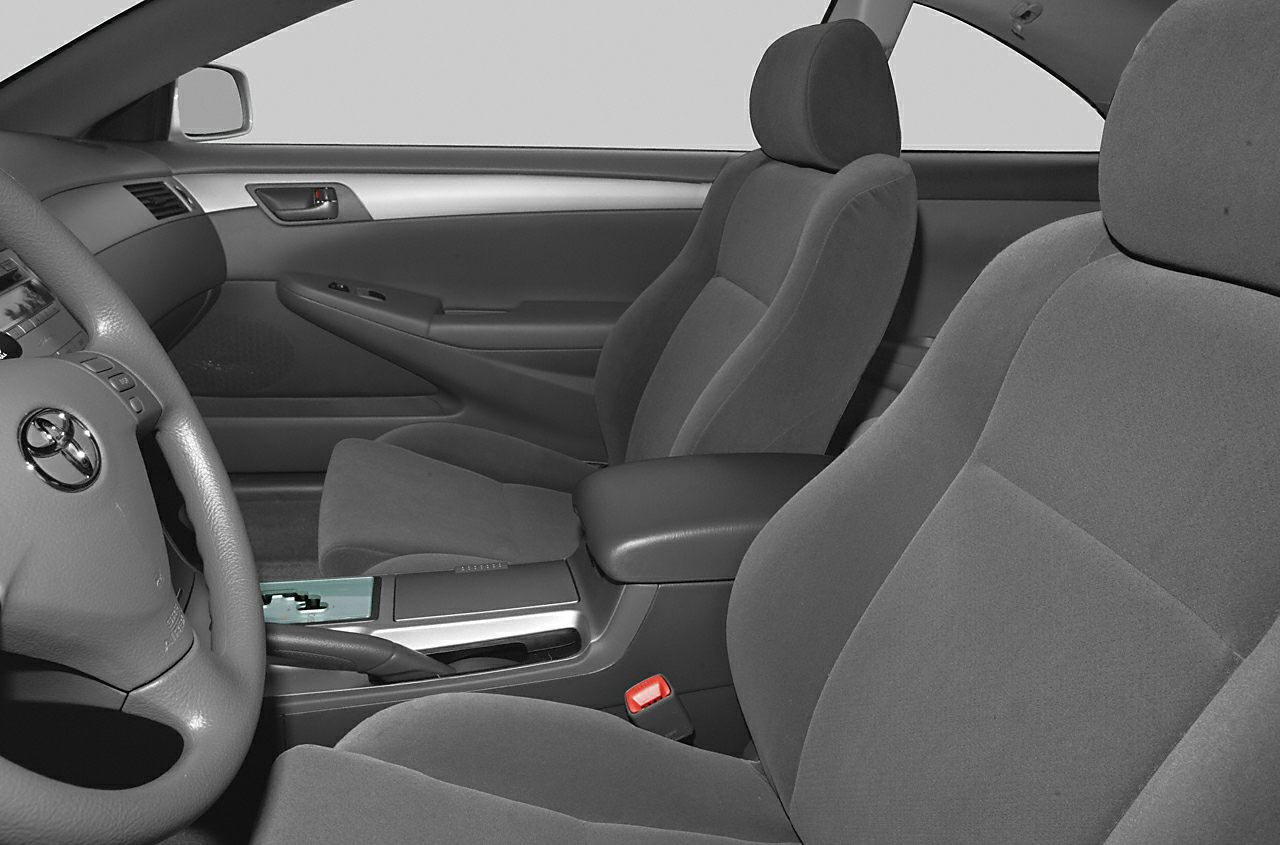 Interior seating and dashboard layout with armrest and gear shift