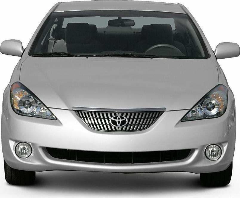 Front view with headlights, chrome grille, and fog lights.