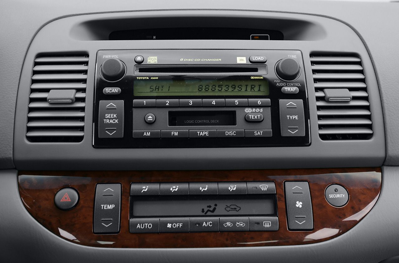 Dashboard with 6-disc CD changer audio system and climate control panel with wood trim