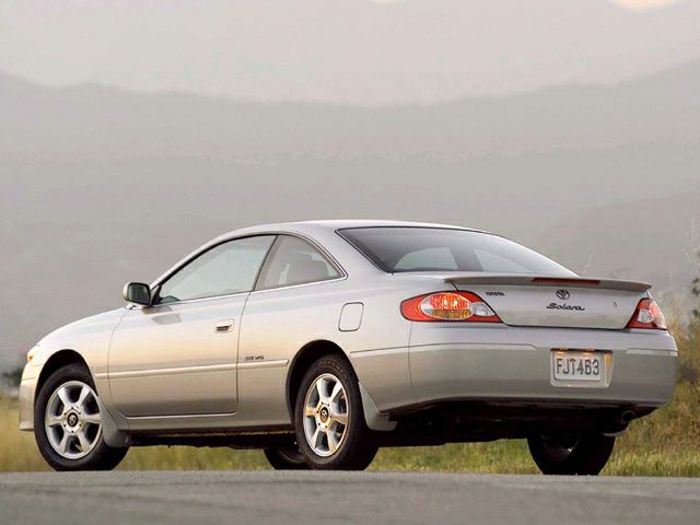 Silver coupe with side and rear view showing tail lights and alloy wheels