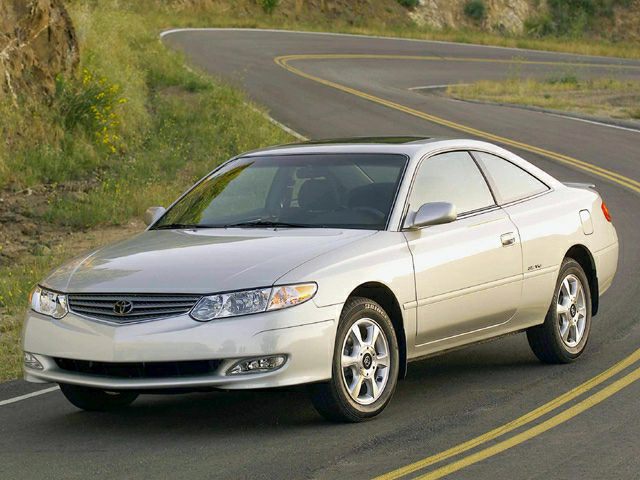Silver 2001 coupe with alloy wheels on winding road