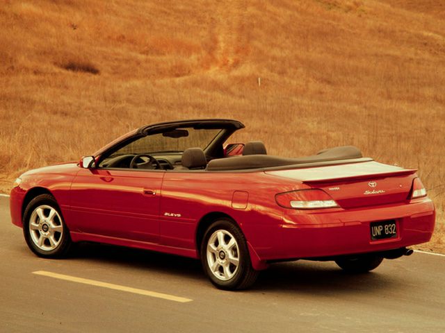 Red convertible coupe with soft top and alloy wheels