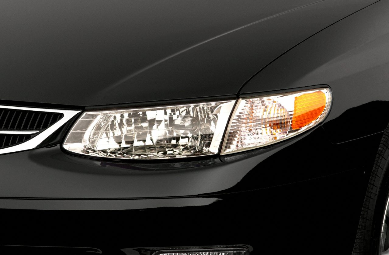 Close-up of front headlight and grille with amber indicator light
