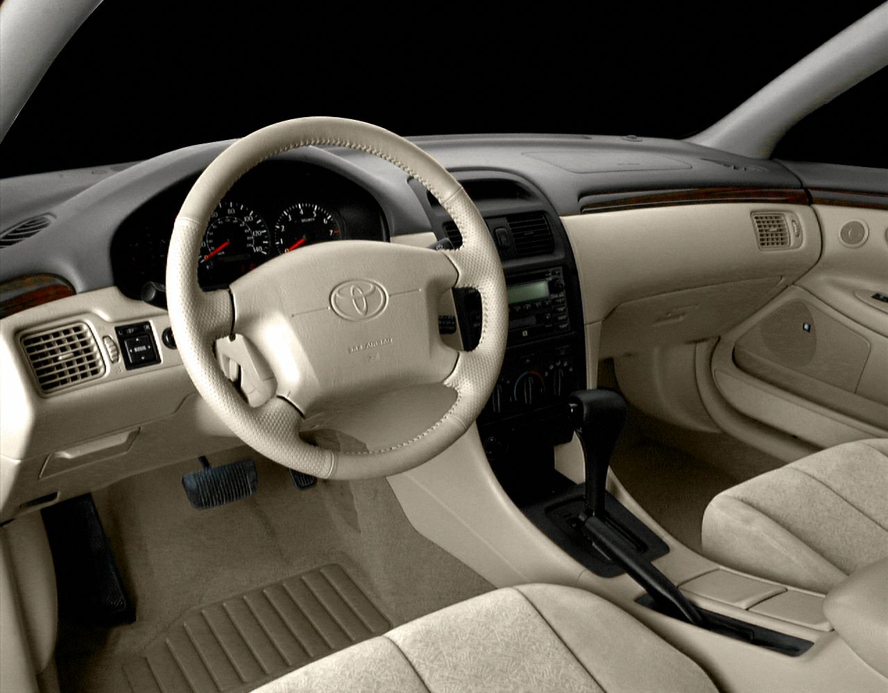 Beige interior dashboard with steering wheel and automatic transmission center console