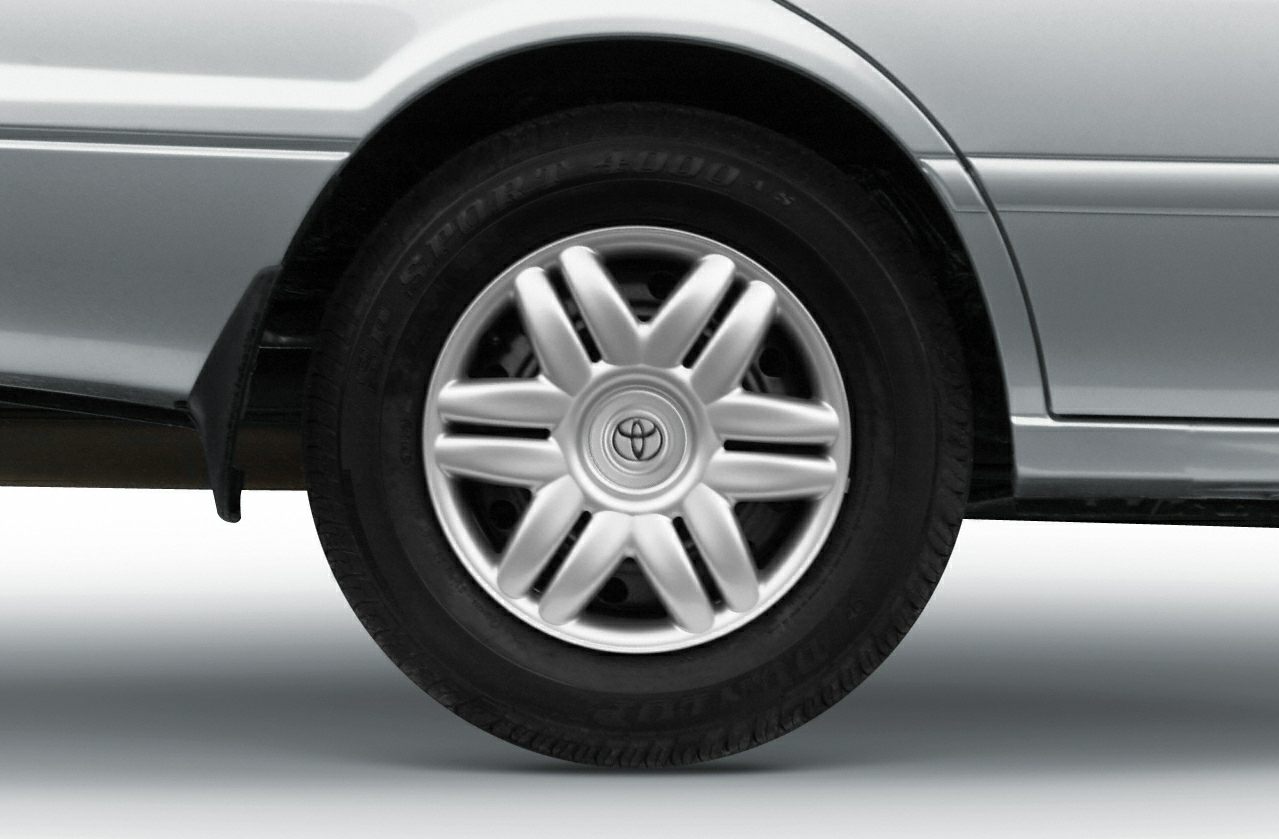 Close-up of alloy wheel and tire on a sedan's rear side.