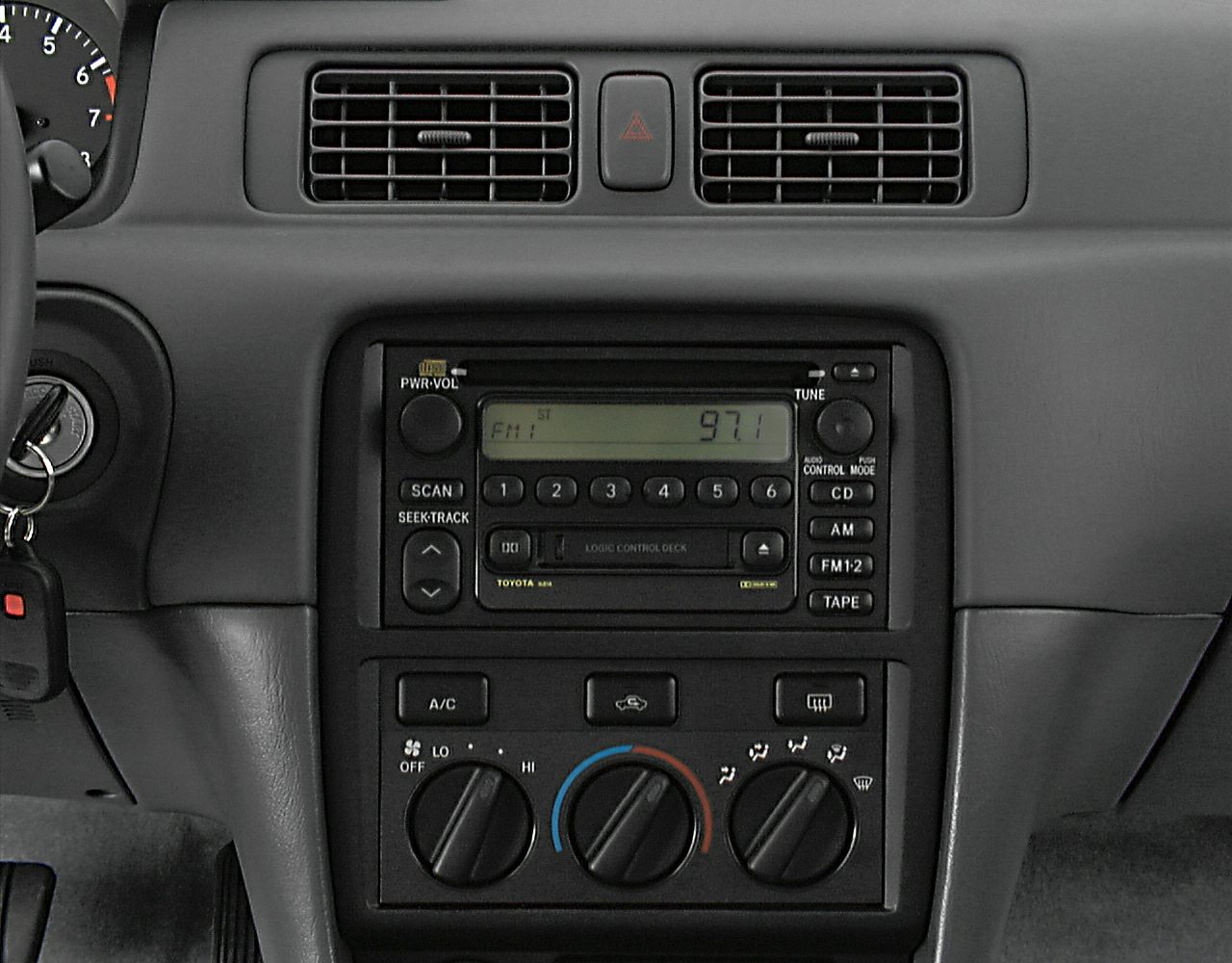 Dashboard radio and manual climate control panel with cassette player