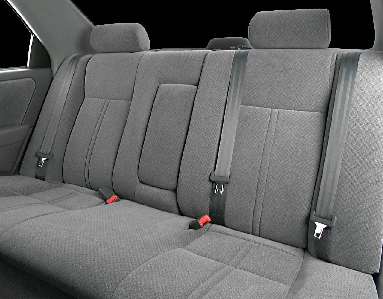 Gray fabric rear seats with headrests and seat belts.