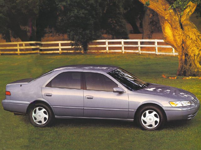 Side profile of a four-door sedan with classic 1990s design.