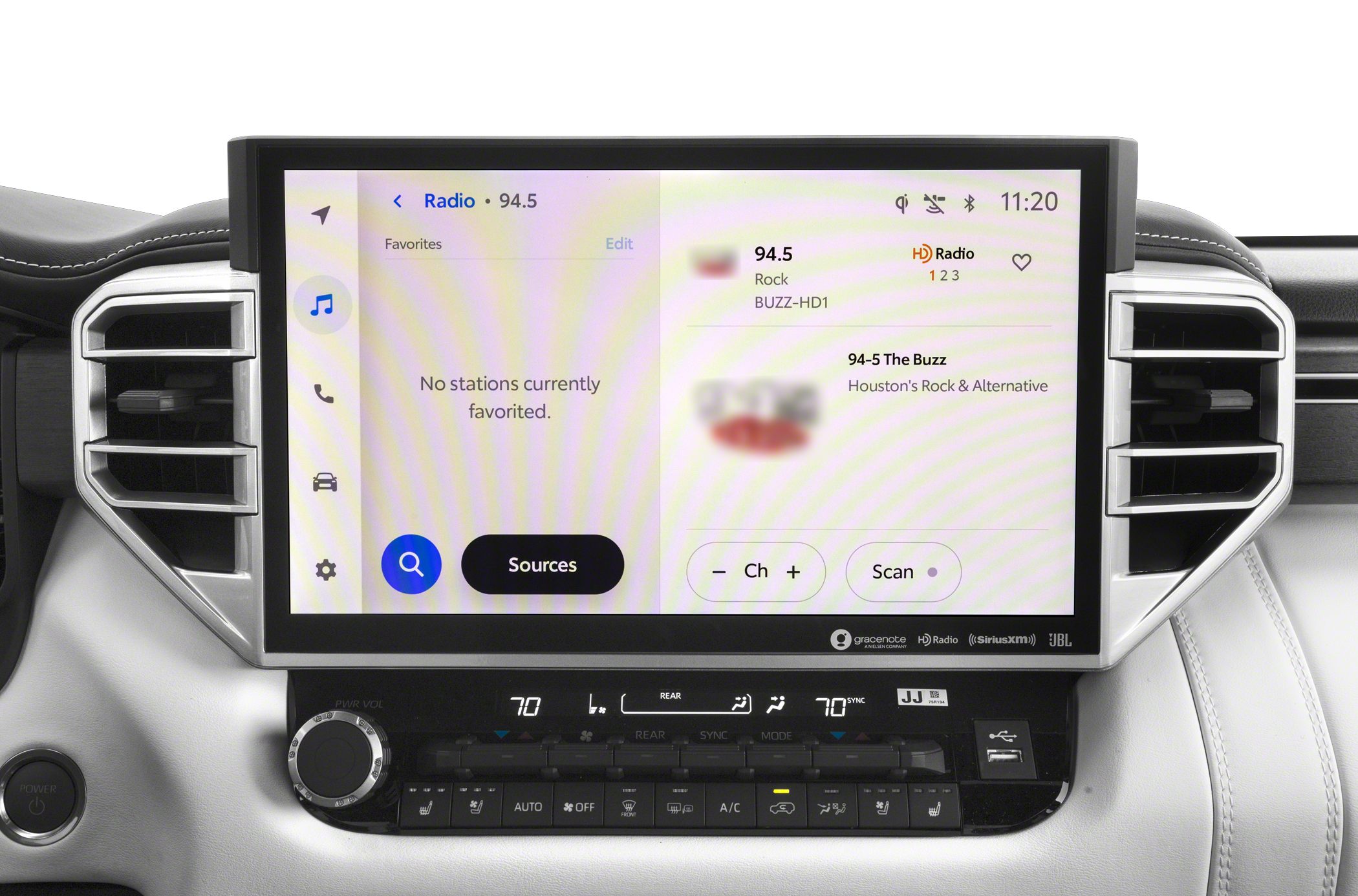 Touchscreen radio interface with climate control panel and air vents.