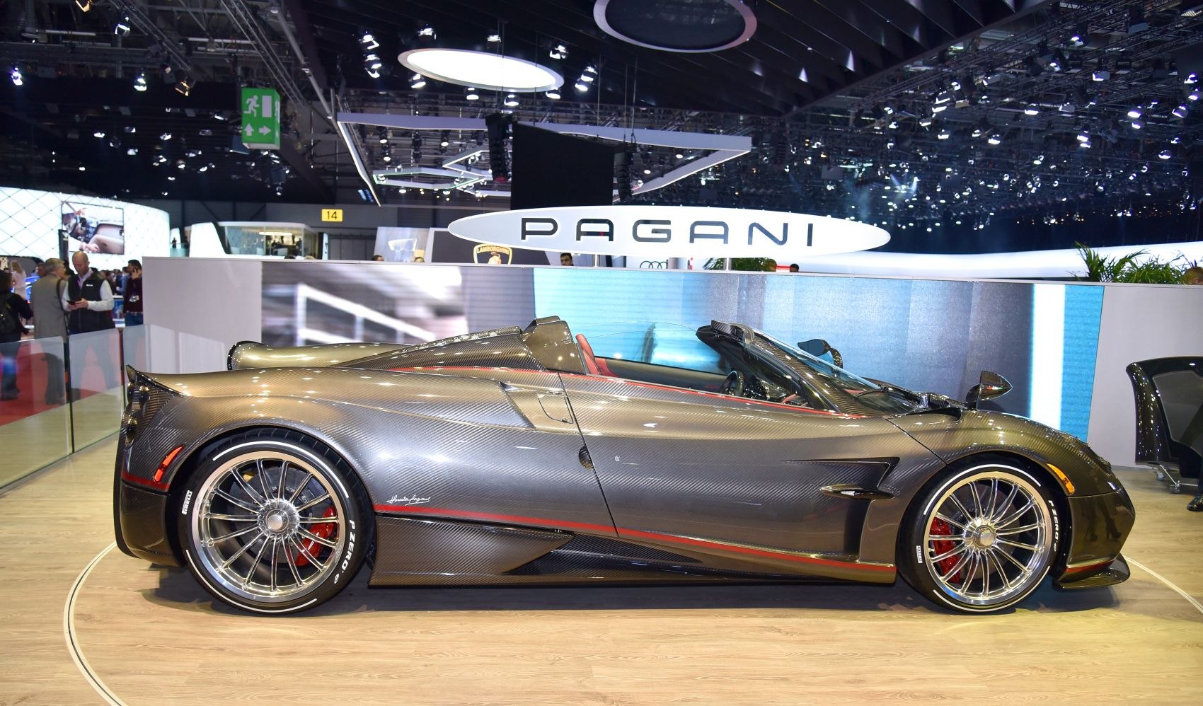 Carbon fiber open-top supercar side profile with distinctive alloy wheels