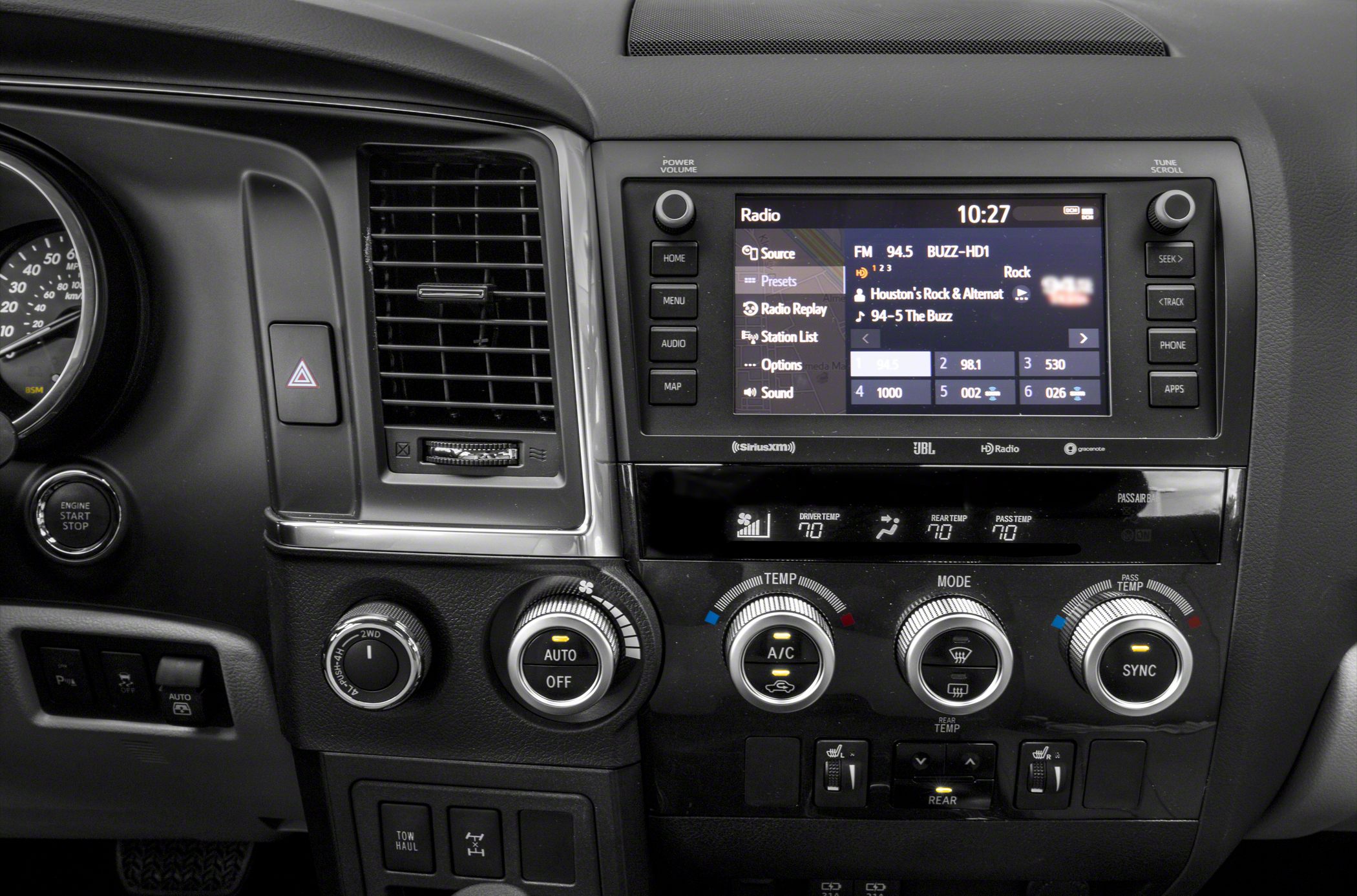 Infotainment screen, climate control dials, driving mode selector