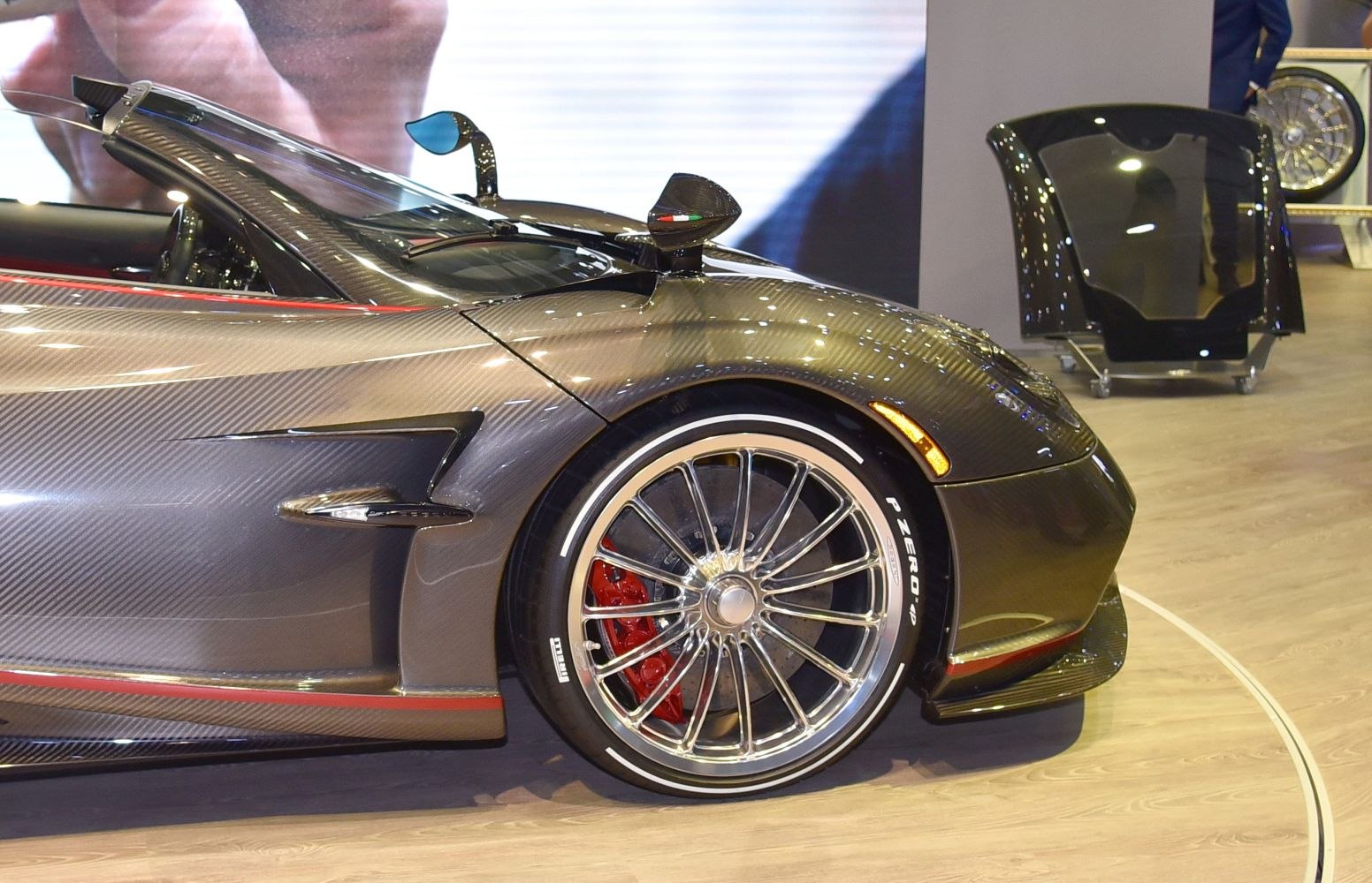 Carbon fiber front quarter, multi-spoke rim, red brake caliper